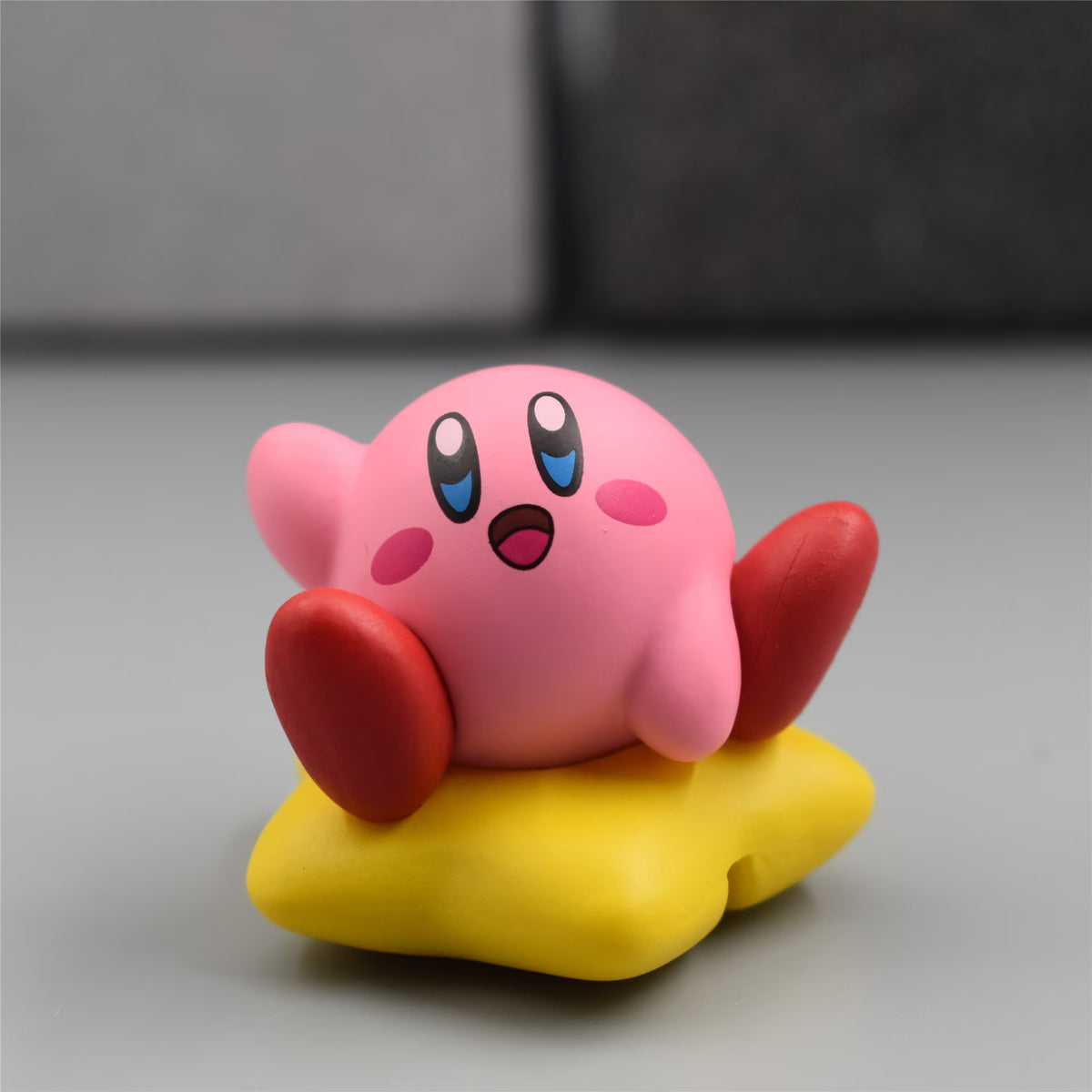Small Kawaii Kirby sitting on star figure