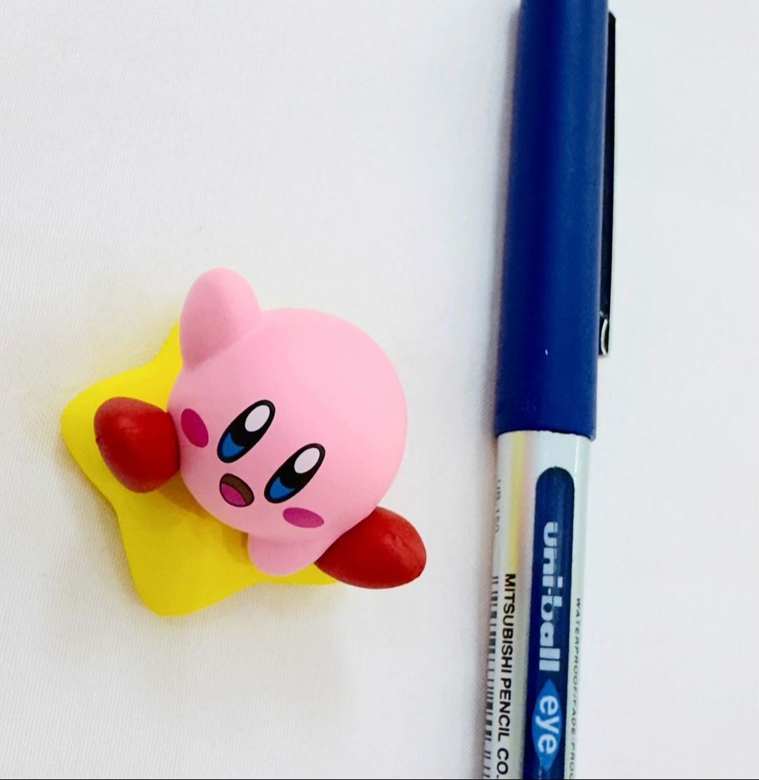 Small Kawaii Kirby sitting on star figure